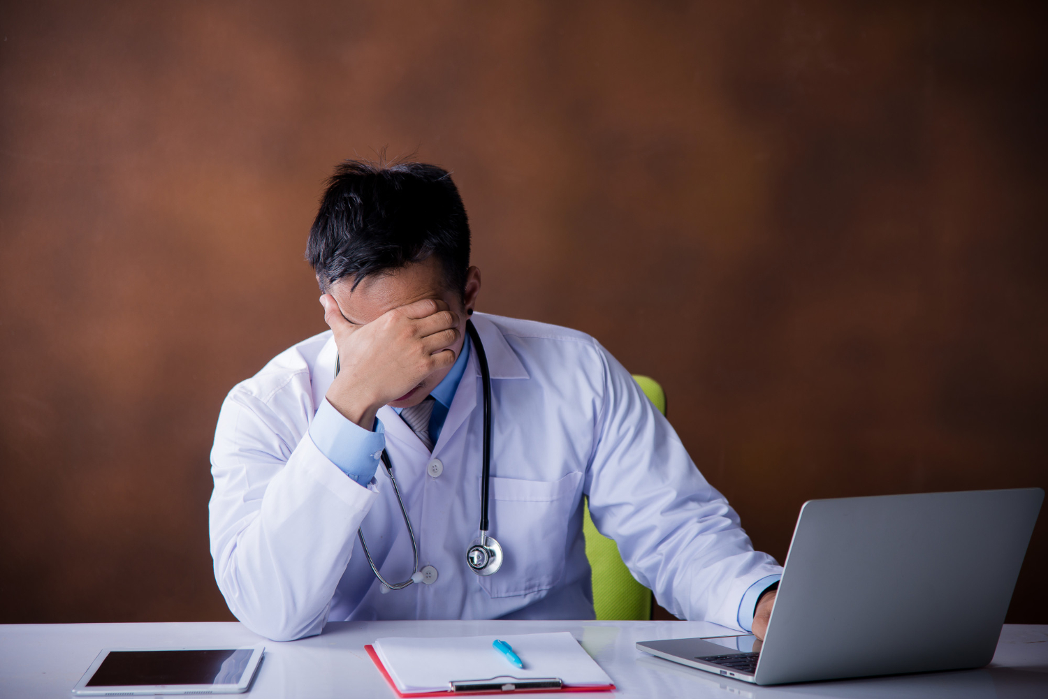 frustrated healthcare provider with computer